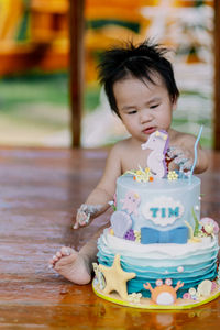 Close-up of cute girl standing on table