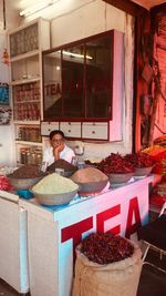 Portrait of a smiling young woman eating food in store