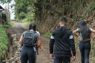 Young latinos hiking through the colombian mountains, on dirt roads and desolate trails.