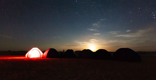 Scenic view of silhouette field against sky at night