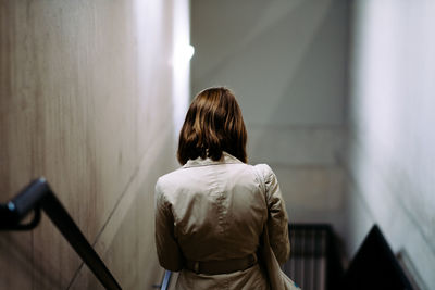 Rear view of woman on stairs