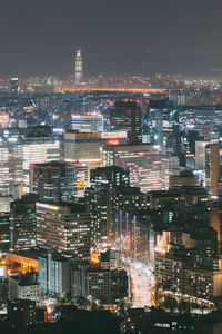 Aerial view of city lit up at night