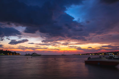Scenic view of sea against dramatic sky during sunset