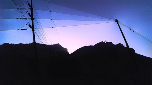 Low angle view of silhouette mountain against clear sky