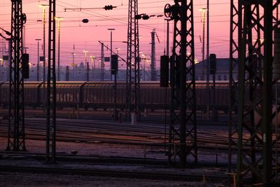 Electricity pylon against sky during sunset