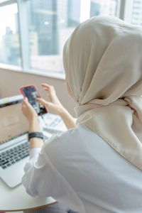 Midsection of woman using mobile phone