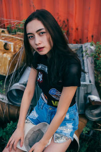 Portrait of young woman sitting outdoors