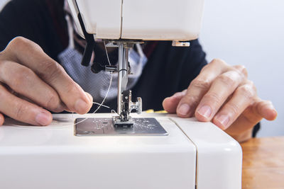 Cropped hands sewing machine