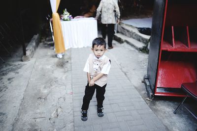 Full length portrait of cute boy standing outdoors