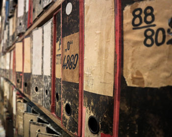 Old ring binders in row on shelves