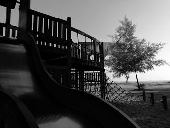 Railing by sea against clear sky