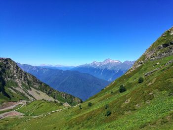 Scenic view of mountains against clear blue sky