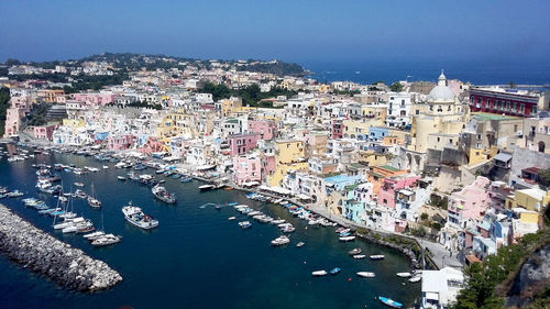 High angle view of townscape by sea against sky