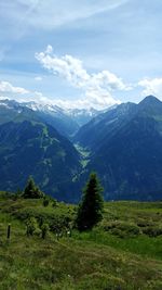 Scenic view of mountains against cloudy sky