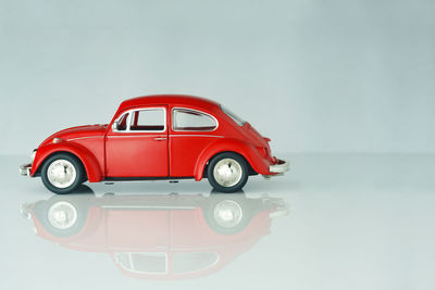 Red toy car against white background