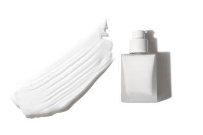 Close-up of beauty products against white background