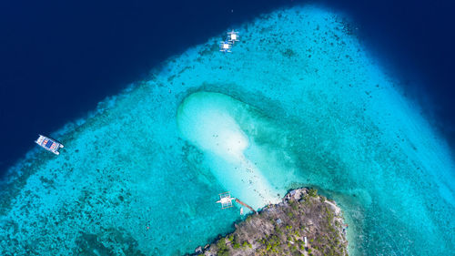 High angle view of people swimming in sea