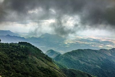 Scenic view of mountains against cloudy sky