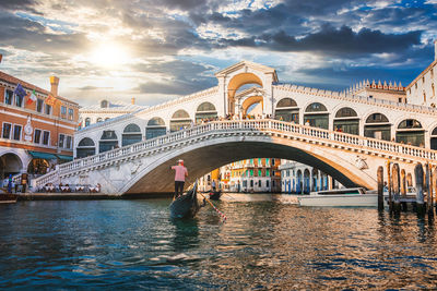 Traditional gondola near world famous canal grande and rialto bridge