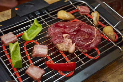 High angle view of meat on barbecue grill