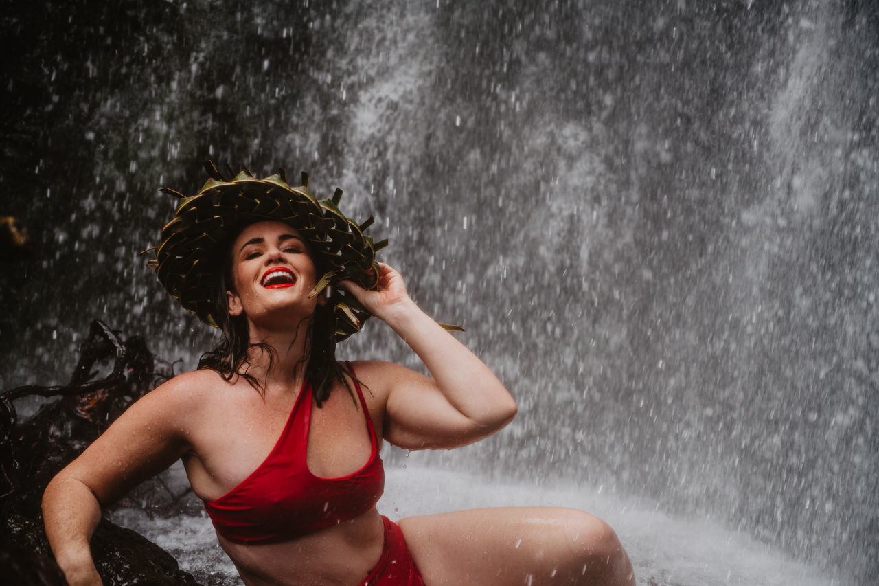 wet, enjoyment, happiness, water, young adult, hair, clothing, one person, rain, nature, women, leisure activity, emotion, motion, young women, hairstyle, lifestyles, fun, outdoors, beautiful woman, wet hair