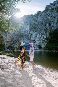 People on rock in water