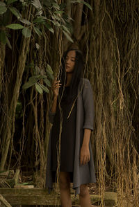 Young woman standing amidst plants