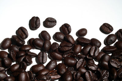 Close-up of coffee beans against white background