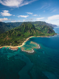 Scenic view of sea and mountains against sky