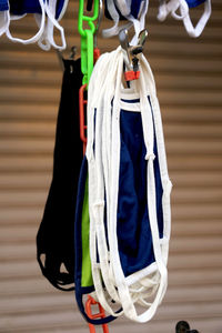 Close-up of clothes hanging on rope against wall