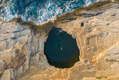 High angle view of rock formations by sea