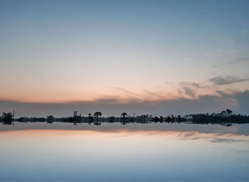 Scenic view of lake against sky during sunset