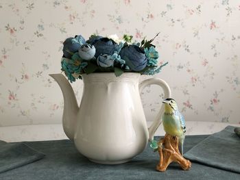 Close-up of roses in vase on table at home