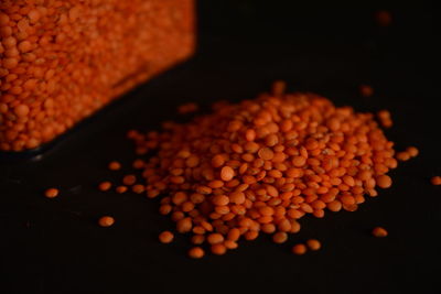 Close-up of red lentils against black background