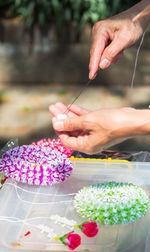 Midsection of person holding bouquet of flowering plant