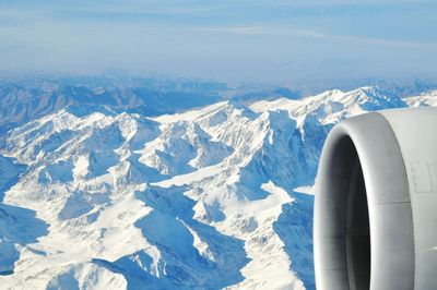 Aerial view of snowcapped mountains from airplane window