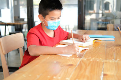 Boy sitting on table