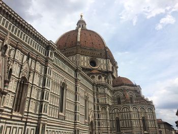 Low angle view of building against cloudy sky