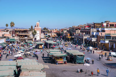 Aerial view over the city square market crowded with people