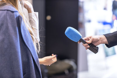 News journalist making media interview with unrecognizable female person