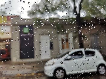 Cars seen through wet window in rainy season