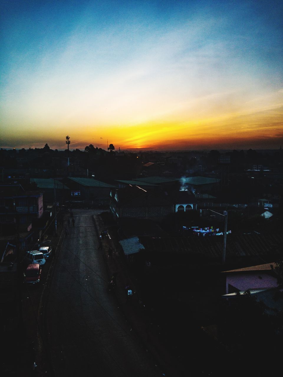 HIGH ANGLE VIEW OF CITYSCAPE DURING SUNSET