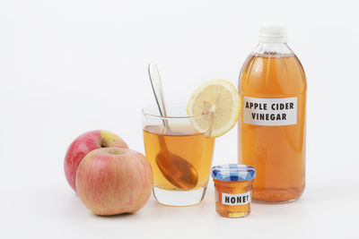 Close-up of fruits on table against white background