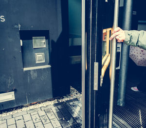 Cropped hand of person holding door