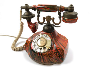 Close-up of telephone against white background