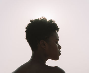 Portrait of young black dark skin woman against sunset