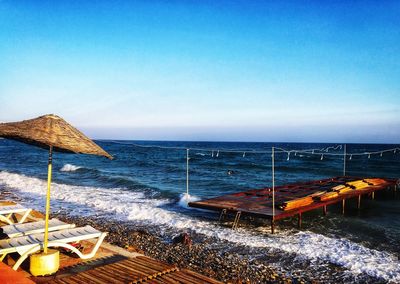 Scenic view of sea against clear blue sky