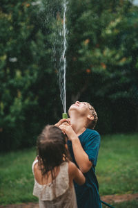 Rear view of girl blowing fountain