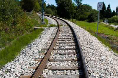 Railroad tracks amidst trees against sky