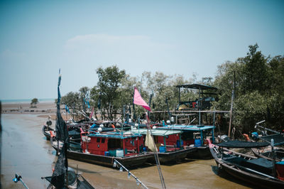 Boats moored in sea against sky